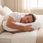 Man side sleeping and hugging the Noa U shaped pillow